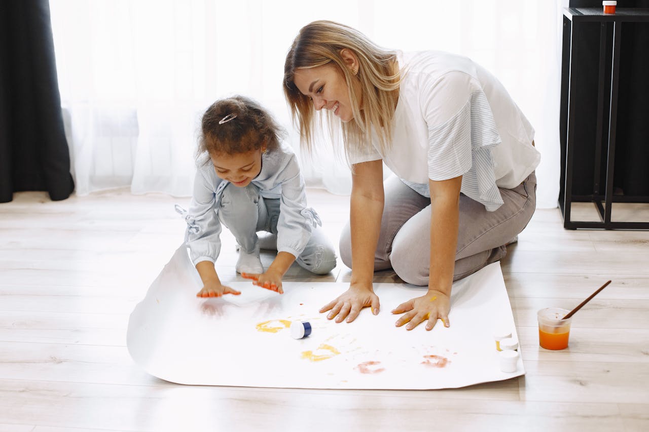 services-01 A mother and daughter joyfully engage in finger painting, fostering creativity and bonding.